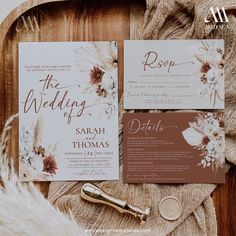 the wedding stationery is laid out on a wooden tray