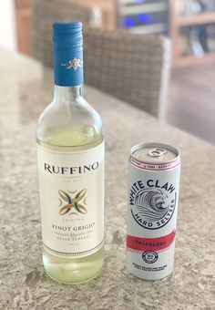 a bottle of wine next to a can of wine