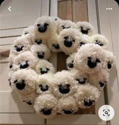 a wreath with black and white sheep on it