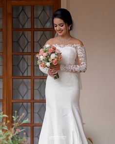 a woman in a wedding dress holding a bouquet