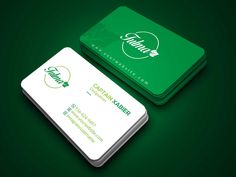 a green and white business card on a dark background