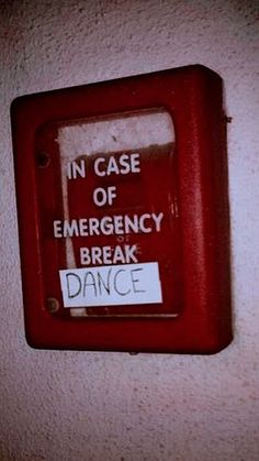 there is a sign on the wall that says in case of emergency break and dance