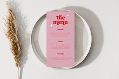 a plate with a menu on it next to a dried plant