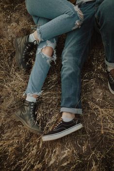 two people sitting next to each other on the ground