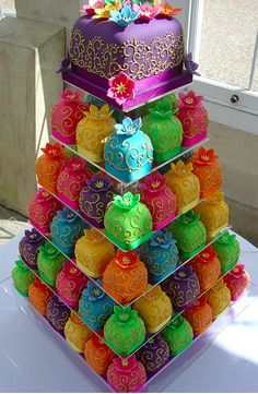 a multi tiered cake with colorful decorations on it