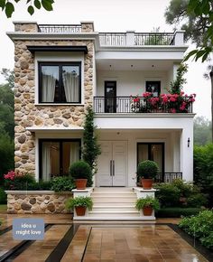 a white house with flowers on the balconies