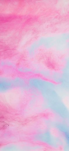 a pink and blue background with white clouds