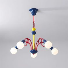 a blue and yellow chandelier hanging from the ceiling with five lights on it