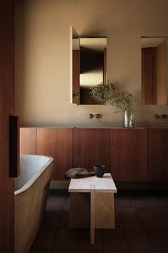 a bathroom with a sink, mirror and bathtub in it's center area