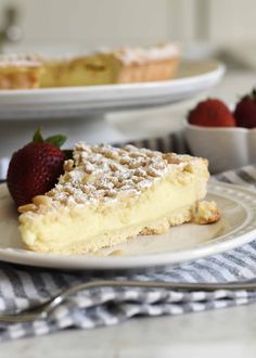 a slice of pie on a plate with strawberries