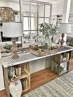 a living room filled with furniture and lots of mirrors on the wall above it's table