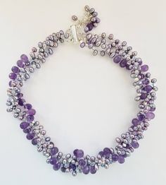 "Exquisite necklace will not disappoint. It is a one of a kind statement piece of jewelry, an investment. Made with beautiful Amethyst, Fresh Water Pearls and using the famous Austrian Crystals and topped off with 925 Sterling Silver. This is a handmade piece. This piece is large. It is 16.5 to 17.5\" long and has a bar clasp.  The faceted natural amethyst drops, pearl and Austrian Crystal wrap is 1.5\" - 2\" Thick." Silver Single Strand Amethyst Necklace, Silver Amethyst Single Strand Necklace, Silver Amethyst Necklace With Single Strand, Luxury Handmade Purple Necklace, Crystal Wrap, Fresh Water Pearl, Austrian Crystal, Collar Necklace, Pandora Charm Bracelet