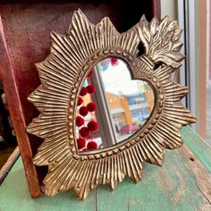 a mirror sitting on top of a wooden table