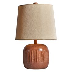 a brown ceramic lamp with a beige shade on the base and a white fabric lampshade