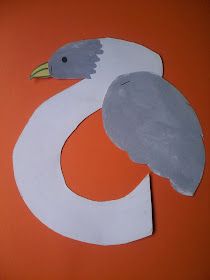 a paper cut out of a bird on an orange background with the letter e in it's center