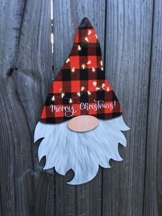 a red and black plaid christmas ornament with a gnome's head