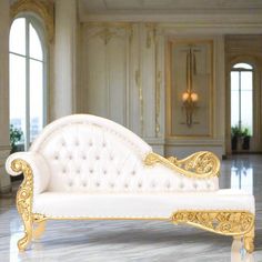 a white and gold couch sitting in a living room