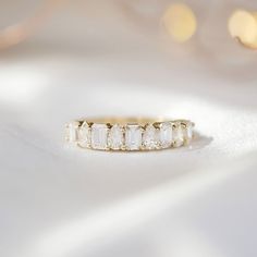 a diamond ring sitting on top of a white cloth