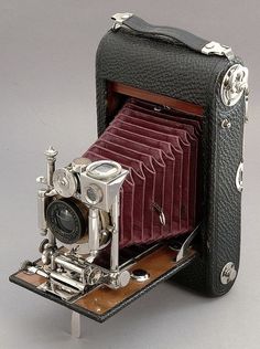 an old fashioned camera sitting on top of a table