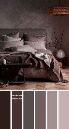 a bedroom with grey walls and brown bedding