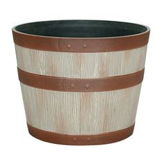 a brown and white striped planter with leather straps on the bottom, sitting in front of a white background