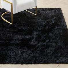 a white chair sitting on top of a black rug