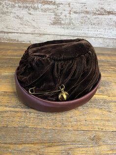 1950s Vintage Brown Velvet Ruched Pillbox Hat with Amber Colored Marble Pin Brooch Great condition!! I have several vintage hats in my shop so check them out!  Please remember that all items in my shop are vintage or antique- they have been loved for years! I try to give the most accurate description I can and provide several photos. Please look at the photos closely before purchasing. I do not accept returns or exchanges. If you have any questions or need more photos, please feel free to reach out!  Thank you for visiting my shop! ☺️ Everyday Vintage Brown Hat, Vintage Brown Hat, One Size Fits Most, Vintage Brown Formal Hat, Vintage Adjustable Distressed Brown Hat, Vintage Brown Cloche Hat, 1950s Woman, Colored Marble, Pillbox Hat, Brown Velvet