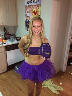 a young woman in a purple outfit posing for a photo with her hands on her hips