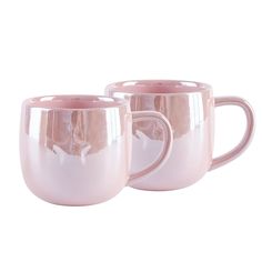 two pink coffee mugs sitting next to each other