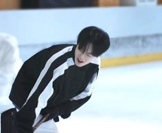 a young man skating on an ice rink