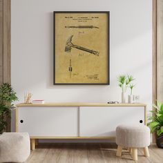 an old fashioned toothbrush poster hangs on the wall above a white cabinet with two stools