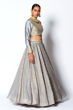 Grey lehenga in a chanderi silk base with woven floral motifs and embroidered waistband. Comes with embroidered one shoulder padded blouse.
Component: 2
Pattern: Woven and Embroidery
Type Of Work: Floral Motifs, Sequin and Pearl
Neckline: One Shoulder
Sleeve Type: Full Sleeves
Fabric: Chanderi Silk and Taffeta Silk
Color: Grey
Other Details: 
Blouse with sequin and pearl work
Closure: Side zip
Occasion: Destination Wedding - Aza Fashions Resham Embroidered Cotton Silk Choli For Reception, Designer Cotton Silk Choli With Gota Work, Party Cotton Silk Choli With Sheer Dupatta, Festive Sheer Dupatta Cotton Silk Lehenga, Cotton Silk Lehenga With Dupatta For Reception, Cotton Silk Lehenga For Diwali Reception, Wedding Cotton Silk Choli With Dupatta, Cotton Silk Lehenga For Reception And Diwali, Semi-stitched Cotton Silk Choli For Reception