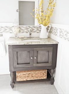 a bathroom sink with a basket underneath it