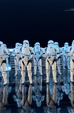 a group of star wars characters standing in front of each other