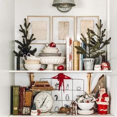 a shelf with christmas decorations and other items on it