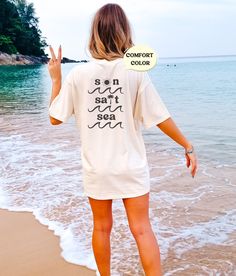 These cute beachy, distressed tees make a perfect beach coverup or lounge tee! Or mix and match colors with friends for a perfect group vacation photo! Please note that this design comes in black ink only, and is only on the back of the tshirt! About Comfort Colors Tees! (Unisex Shirts!) These ultra soft pigment dyed shirts are one of our best sellers ⭐️ 100% ring spun cotton ⭐️ PRESHRUNK, soft-washed, garment-dyed fabric ⭐️ Set-in sleeves ⭐️ Double-needle stitched sleeves and bottom hem ⭐️ Twill taped shoulder-to-shoulder ⭐️ 1" ribbed collar with double-needle topstitched neckline HOW TO PLACE AN ORDER 1. View all color and size charts before you place your order. 2. Select your shirt "SIZE" and "COLOR". 3. Click add to cart **Repeat process for each tshirt WASHING INSTRUCTIONS Use cold w Relaxed Summer T-shirt For Loungewear, Relaxed Summer Loungewear T-shirt, Relaxed Short Sleeve T-shirt For Vacation, Relaxed Beach Cover-up Tops, Relaxed Fit Summer T-shirt, Oversized Casual T-shirt For Beach Season, Summer Oversized Relaxed T-shirt, White T-shirt For Beach Vacation, Oversized Summer Beach Cover-up Top