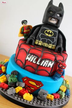 a lego cake with batman and superman movie characters on it