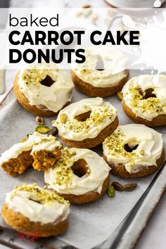 baked carrot cake donuts with white frosting and pistachio sprinkles