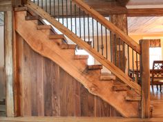 the stairs are made out of wood and have metal railings