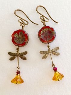 "Adorable red/orange Picasso Czech glass Hawaiian flowers with topaz bellflowers and vintage bronze stamped dragonfly charms. Red/orange 14 mm Czech flowers with rustic Picasso finish are wire wrapped in vintage bronze with 6 x 9 mm translucent topaz yellow bellflowers accented with tiny burnt orange crystals. Lightweight dangles hang on vintage bronze French ear wires. Total drop is 2 1/4\"." Paris Charm Bracelet, Topaz Yellow, Dragonfly Charm, Personalized Quilt, Orange Crystals, Hawaiian Flowers, Gifts For An Artist, Glass Flowers, Orange Flowers