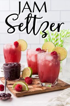 two glasses filled with raspberry jam and limeade sitting on a cutting board