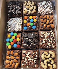 a box filled with lots of different types of desserts on top of each other