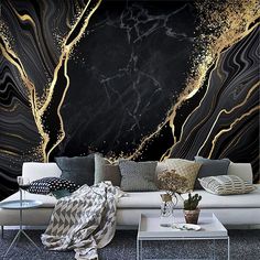 a living room with black and gold wallpaper, white couches and coffee table