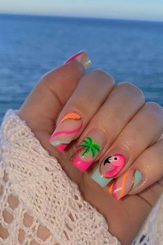 Embrace the tropical vibes with these almond-shaped summer vacation nails. A playful pink base is accented with a charming flamingo design, bringing a splash of vibrant personality. Swirling stripes of hot pink, pastel blue, and shining gold elegantly wrap across other nails, enhanced by a soothing palm tree motif that whispers the promise of relaxing beach days. The combination of pastels and lively hues make for a perfect summertime accessory. Beachy and chic! 🌴🦩  // Photo Credit: Instagram @nailsbykatyrose Lilly Pulitzer Nails Designs, Tropical Nails French Tips, Palm Tree Design Nails, Love Island Nails, Summer Trip Nails, Nails For Beach Vacation Simple, Margaritaville Nails, Hot Summer Nails 2024, Pool Nails Designs