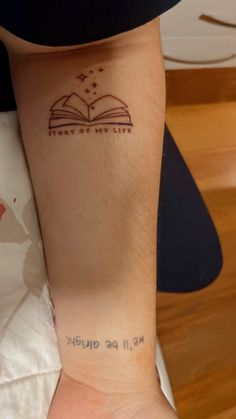 a person with a book tattoo on their left arm and the words, i am sorry to you