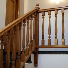 a wooden banister next to a set of stairs