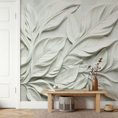 a room with a wooden table and white wallpaper on the walls, along with a vase filled with flowers