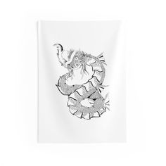 a black and white drawing of a dragon on a white wall hanging from a hook