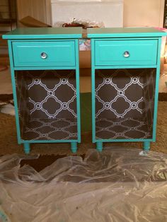 two blue and brown dressers sitting next to each other on top of plastic covering the floor