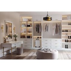 a white closet with lots of shoes on the shelves and clothes hanging up in it